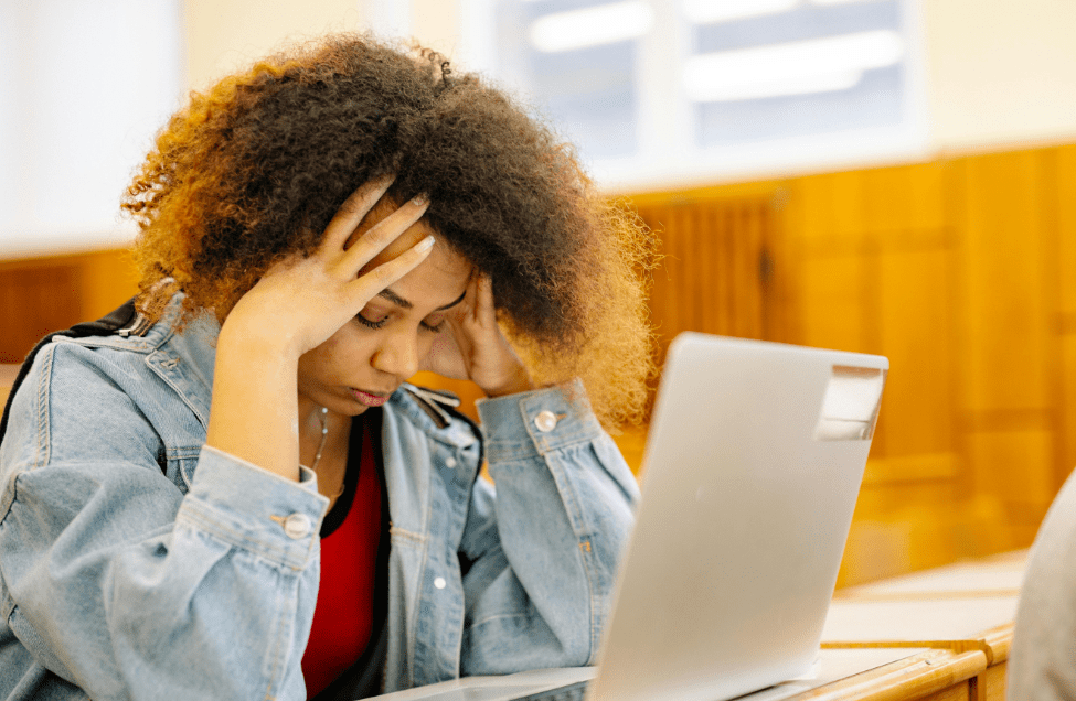 stressed student infront of laptop