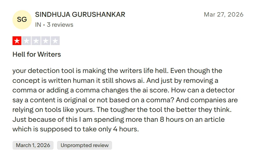 One-star Trustpilot review alleging that comma changes affected Originality AI scores on human-written content.